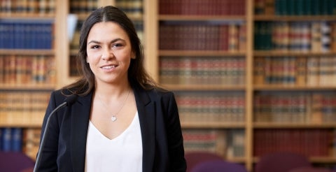 A woman in a library studying how to become a lawyer in Australia.