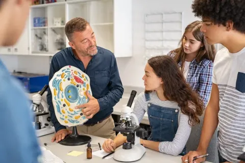 An educational leader stands before a team, representing the importance of educational leadership in schools.