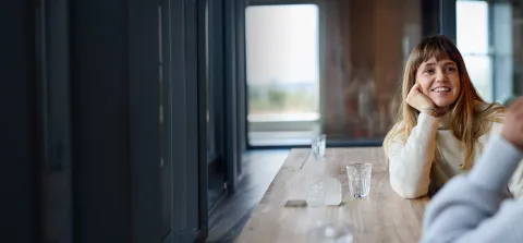 1. A woman and a man are seated at a table, engaged in conversation.1. A woman and a man are seated at a table, engaged in conversation.
