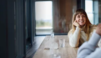 1. A woman and a man are seated at a table, engaged in conversation.1. A woman and a man are seated at a table, engaged in conversation.